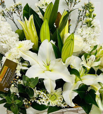 A white lilies and white flowers mixed with green foliage in a floral arrangement delivered brisbane, brendale florist delivery, brendale white flower delivery, brendale sympathy flowers delivered, eatons hill white flowers, albany creek sympathy white flowers delivered, flower delivery to pinaroo, white flowers to albany creek remorial flower delivery, cashmere sympathy flowers, warner sympathy flower delivery, strathpine sympathy flower delivery, bald hills flower delivery