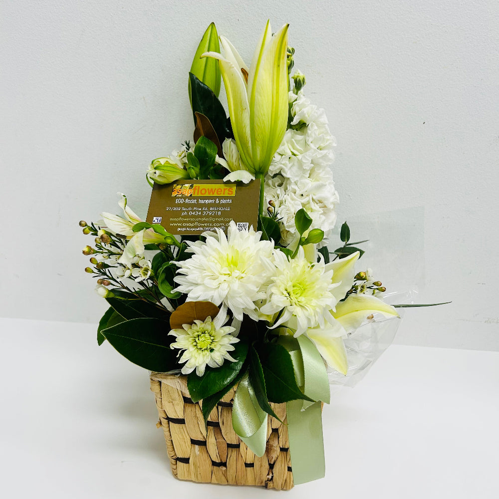A white lilies and white flowers mixed with green foliage in a floral arrangement delivered brisbane, brendale florist delivery, brendale white flower delivery, brendale sympathy flowers delivered, eatons hill white flowers, albany creek sympathy white flowers delivered, flower delivery to pinaroo, white flowers to albany creek remorial flower delivery, cashmere sympathy flowers, warner sympathy flower delivery, strathpine sympathy flower delivery, bald hills flower delivery